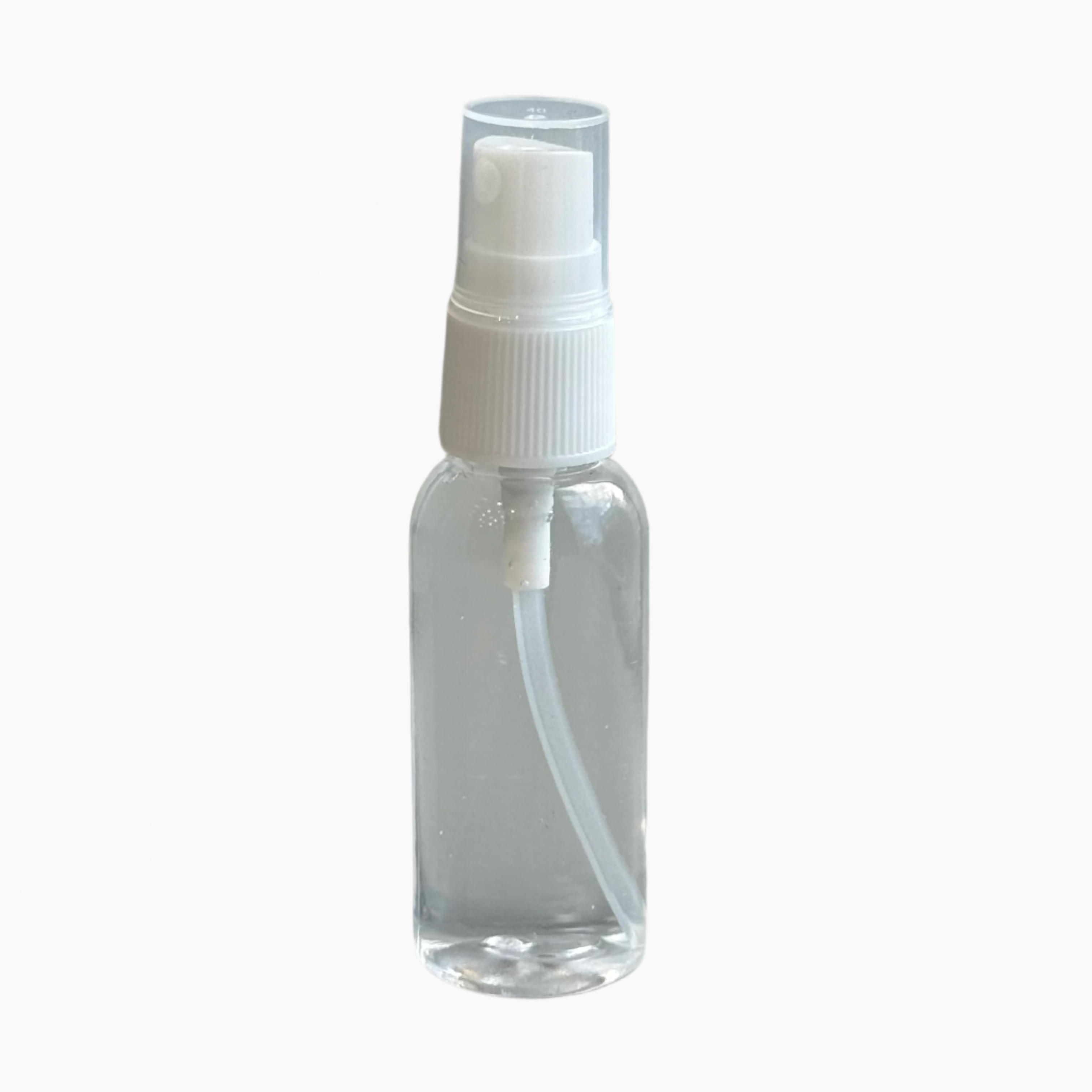 Clear spray bottle with white cap